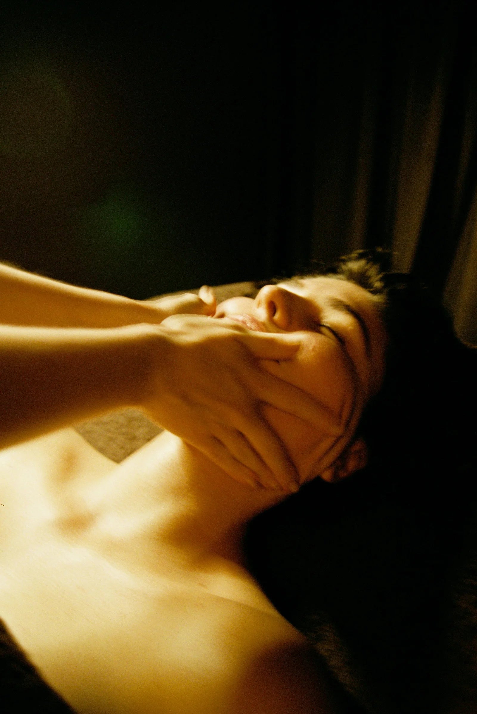 Facial therapist releasing jaw and tension during a RE Align facial treatment in Auckland